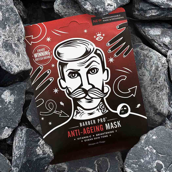 An anti-ageing facial sheet mask pouch sitting on rocks