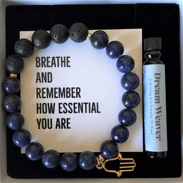 The white box packaging for the bracelet showing the bottle of essential oil included inside