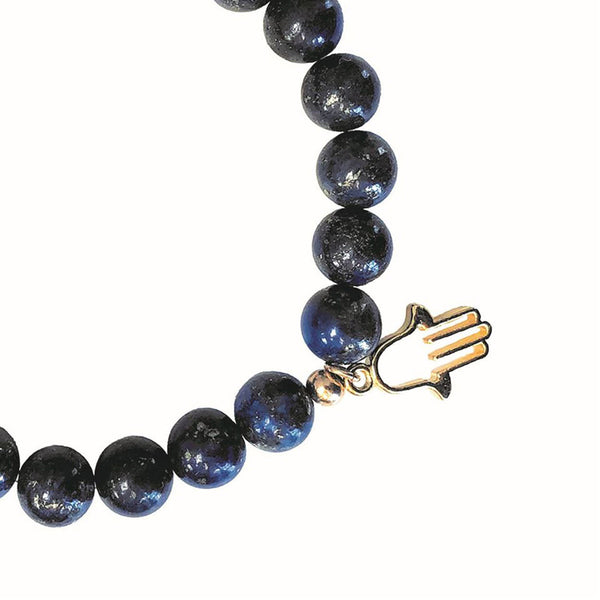 A close up of the diffuser bracelet and hamsa charm