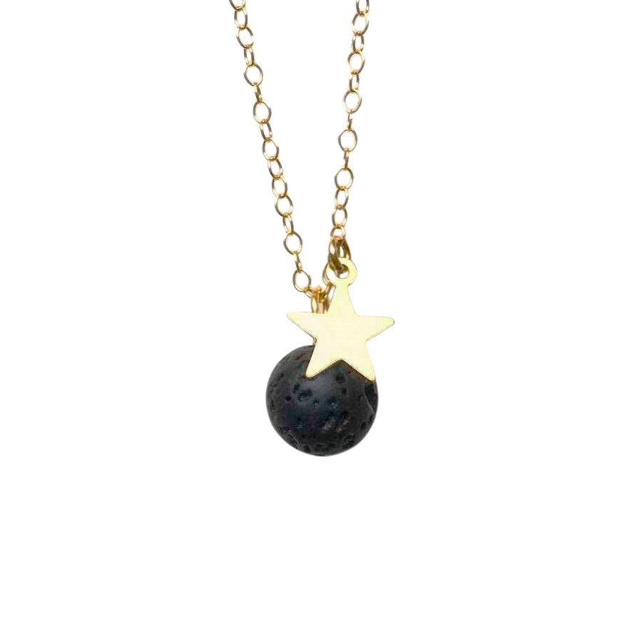 A round lava stone and gold star pendant attached to a gold chain