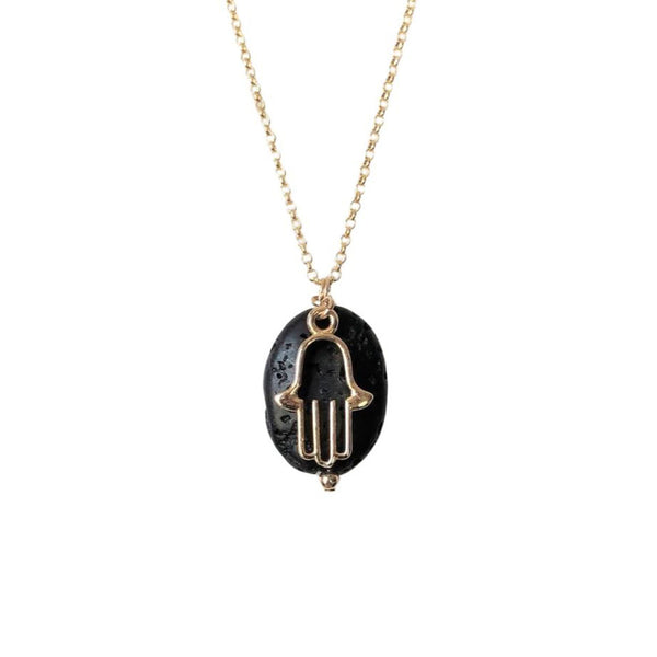 An oval shaped lava stone and gold hamsa charm pendant attached to the gold chain aromatherapy necklace