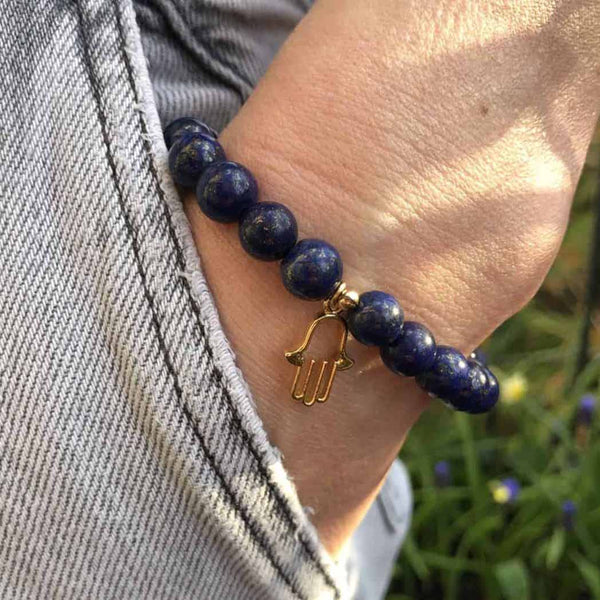 A woman wearing a hamsa diffuser bracelet