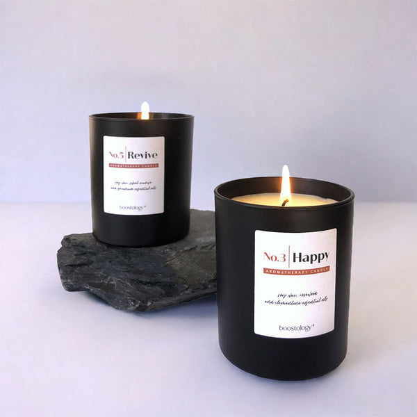Two essential oil candles on slate stone