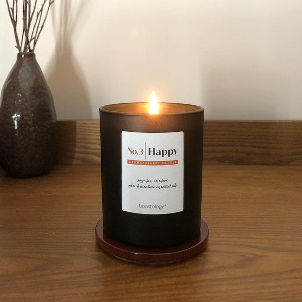 A soy wax candle on a wooden bedside table