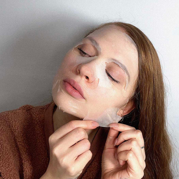 A woman wearing a korean style sheet face mask