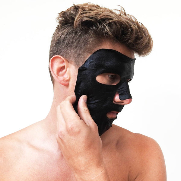 A man wearing a black sheet face mask
