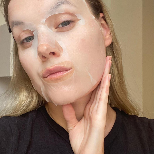 A woman wearing a korean style face sheet mask