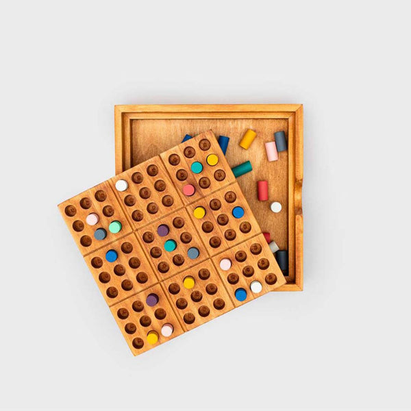 A peace of mind board with coloured playing pieces set inside