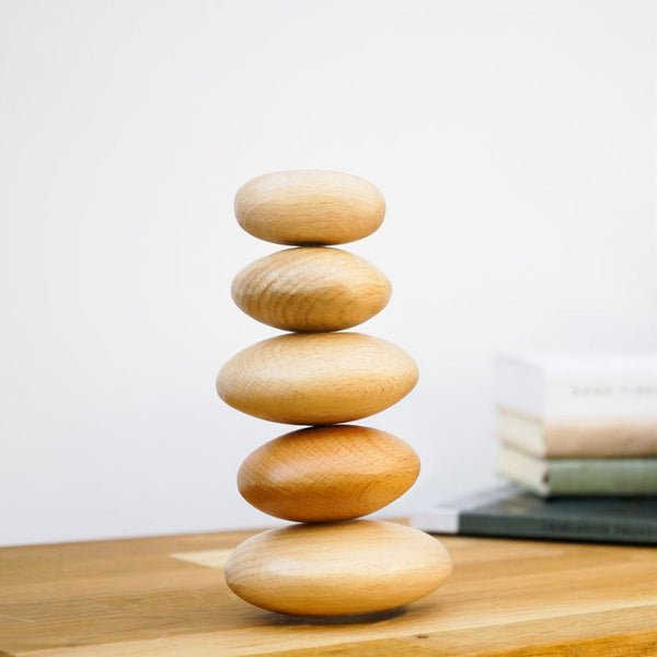 5 wooden pebbles stacked one on top of the other