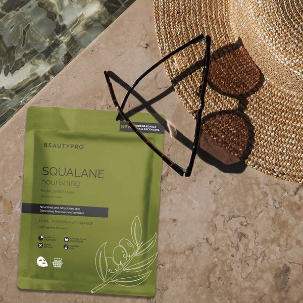 A nourishing face mask pouch by a swimming pool