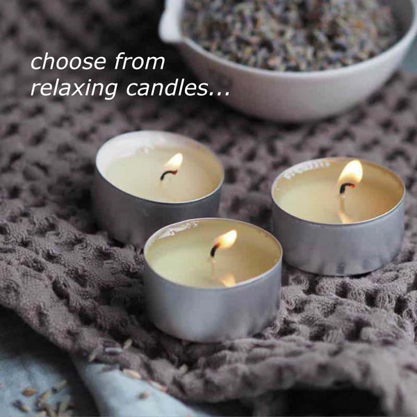 Three tea light candles next to a bowl of lavender buds
