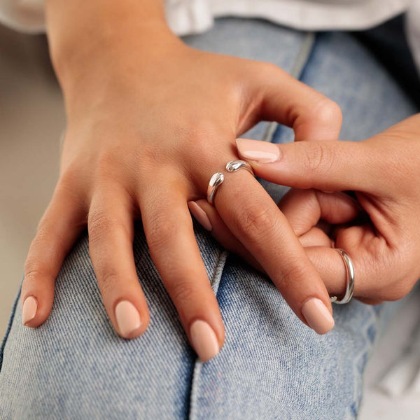 A woman wearing a silver paw ring on her finger