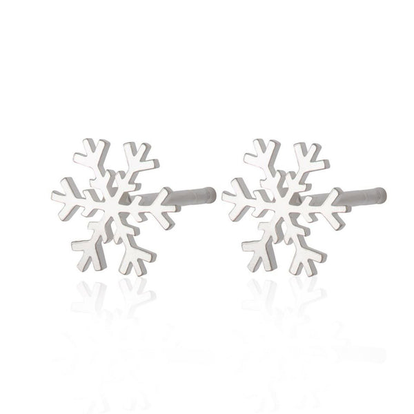Two sterling silver snowflake earings on a white background