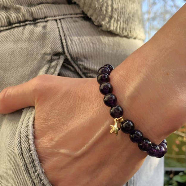 A woman wearing a purple amethyst diffuser bracelet