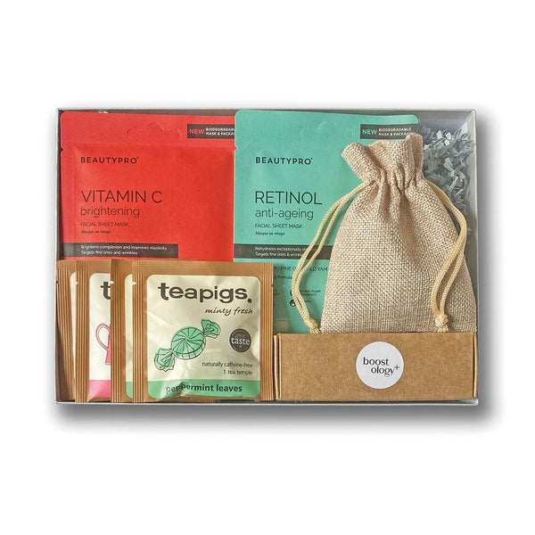 A grey gift hamper filled with wellbeing treats