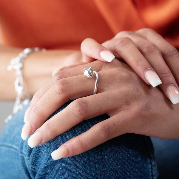A silver cat ring on a womans hand