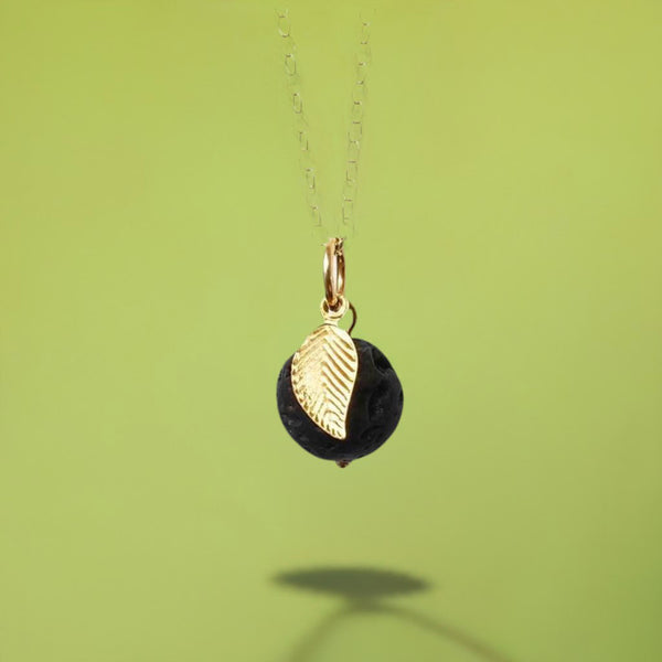 The necklace and its shadow on a green background