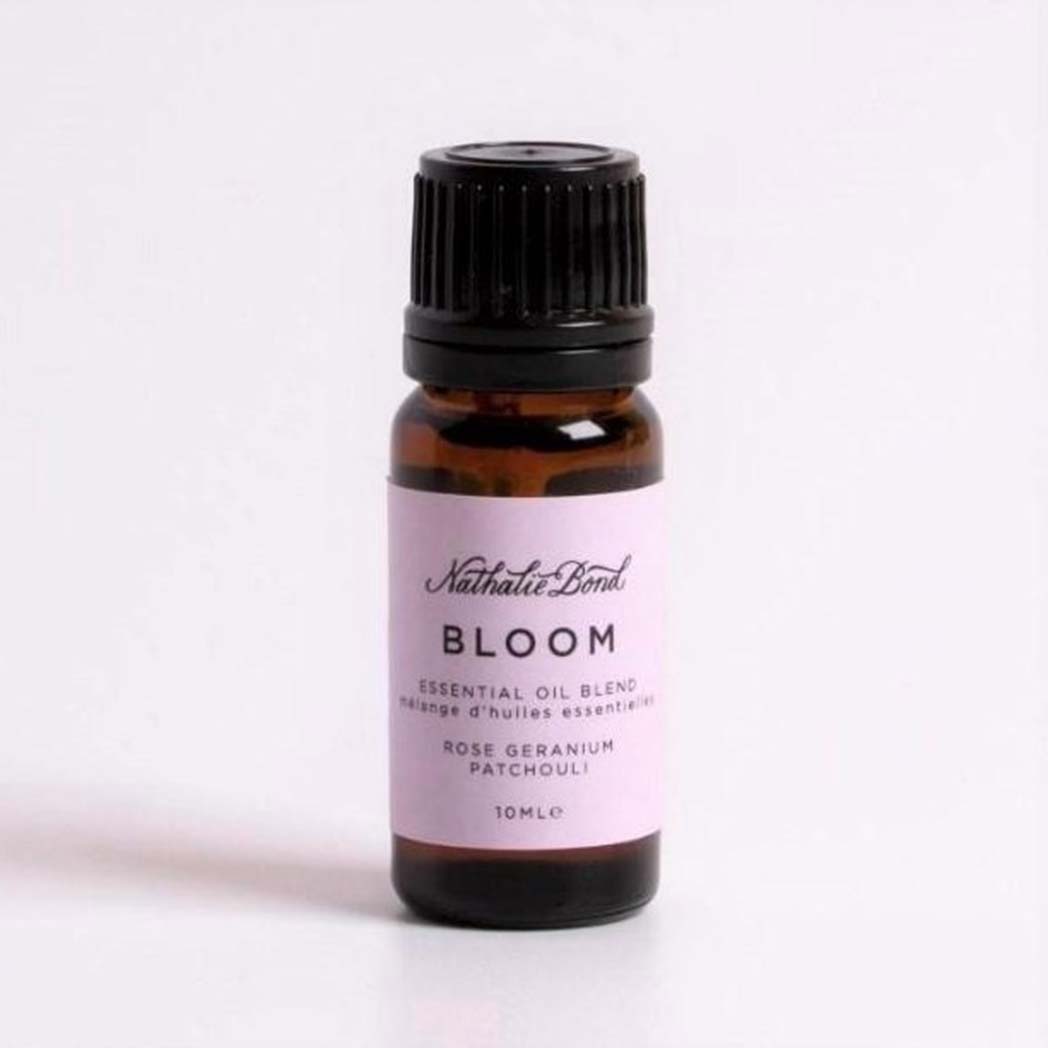 A bottle of Rose, Geranium & Patchouli Essential Oil On A White Background