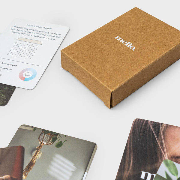 Brown box with 'mello' branding on a white surface with deck of calm cards