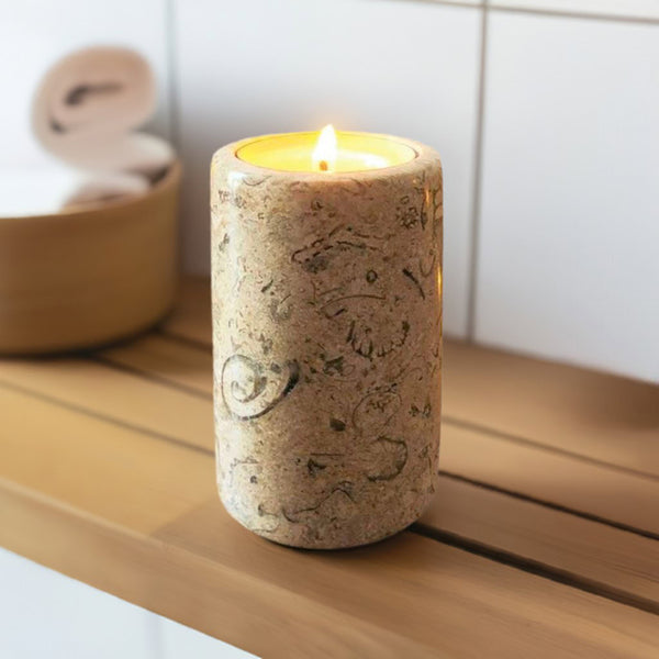 A fossil stone candle on a bathroom shelf