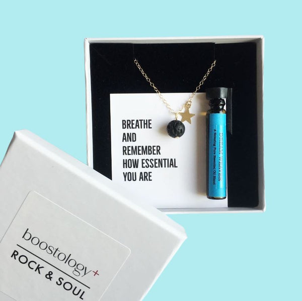A gold star necklace with the words "breathe and remember how essential you are"