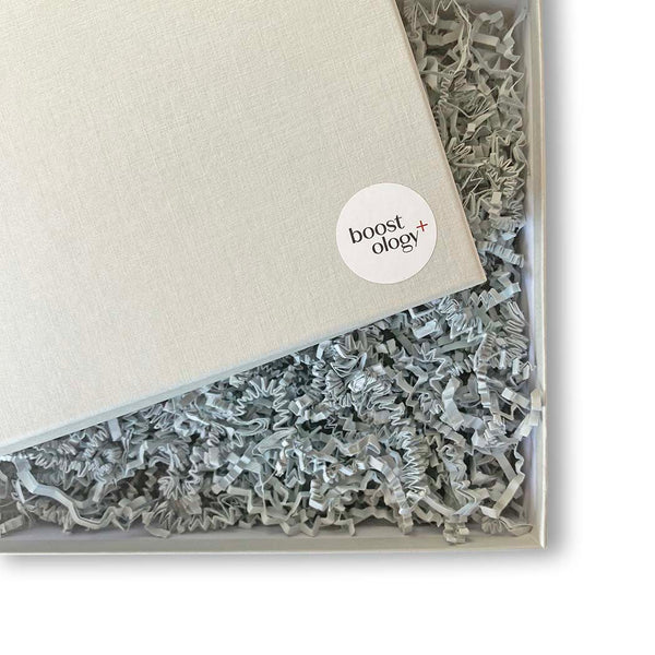 Hamper box with grey crinkled paper on a white background