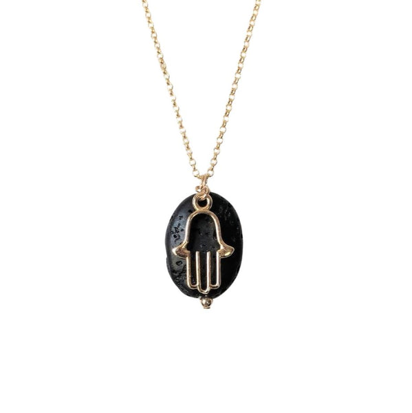 An oval shaped lava stone and gold hamsa charm pendant attached to a gold chain