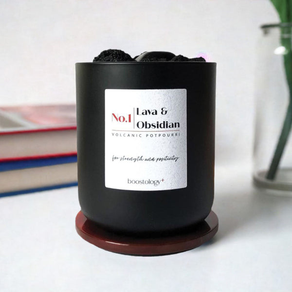 A Volcanic Potpourri essential oil diffuser with some books and a vase in the background