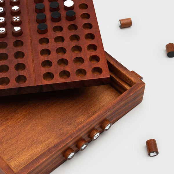 The four hidden symbol pegs in the side of a codebreaker game