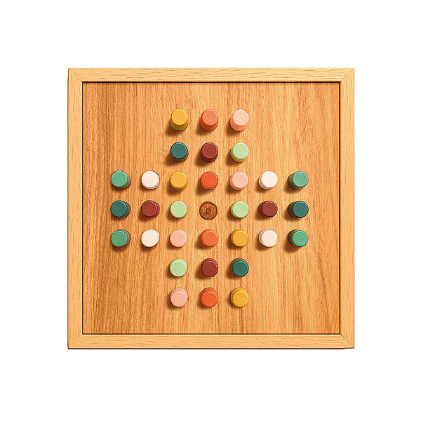 Colourful pegs in a wooden solitaire board game on a white background
