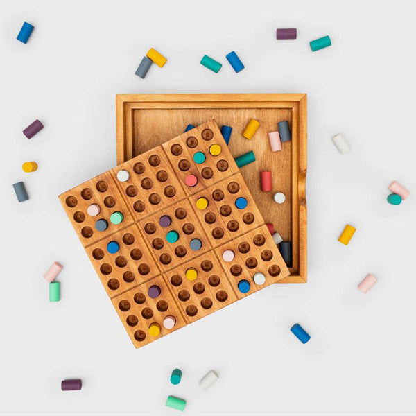 Coloured wooden pegs scattered around the peace of mind puzzle