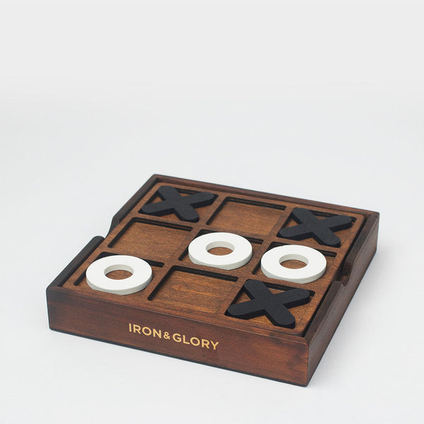 Black crosses and white noughts sitting on top of the board