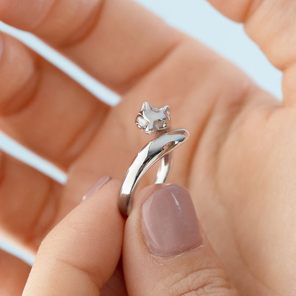 A close up of a woman holding a sterling silver fox ring