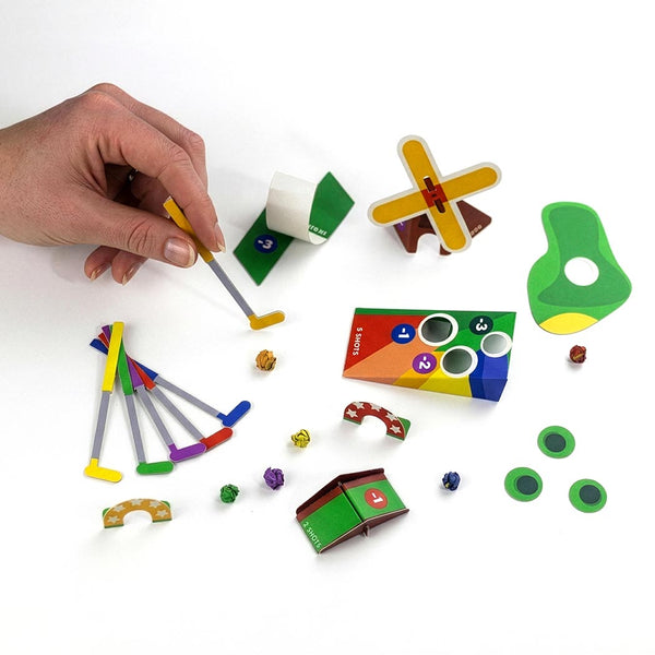 Colourful golf game pieces on a white background