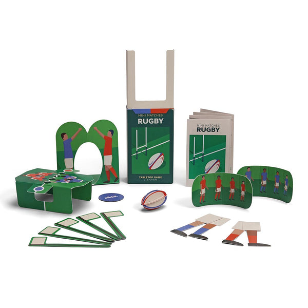 A rugby game set displayed on a white background, including a green rugby goal,  player cutouts, field markers, and a rugby ball.