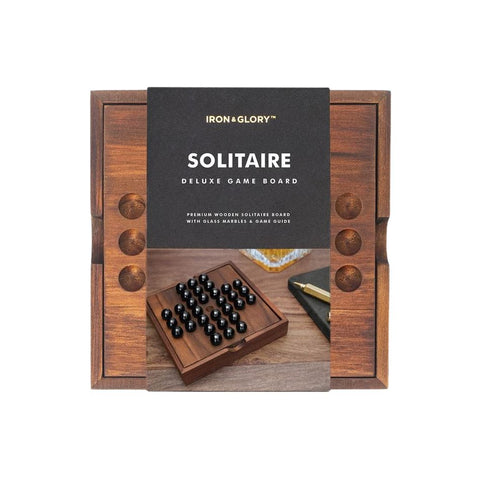 A wooden Solitaire game in its packaging