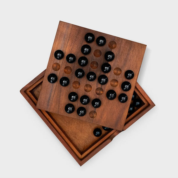 A solitaire game with the lid off showing the playing pieces inside