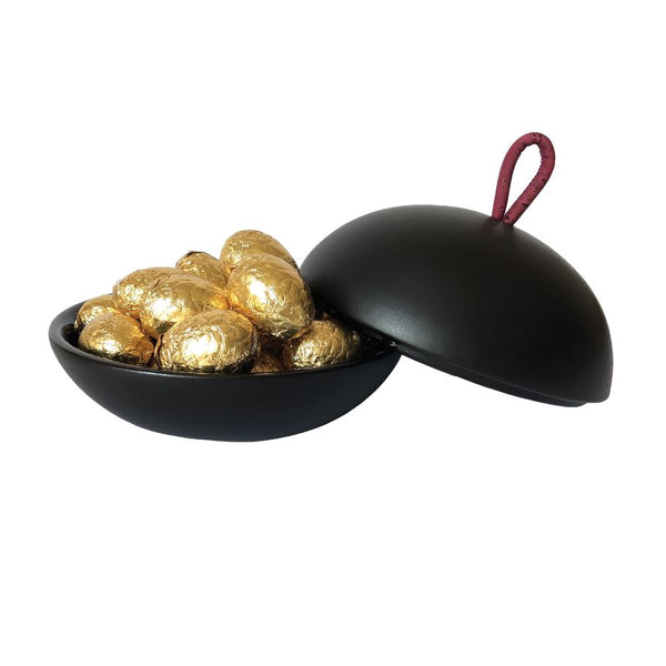 A black bonbonniere filled with gold chocolate eggs