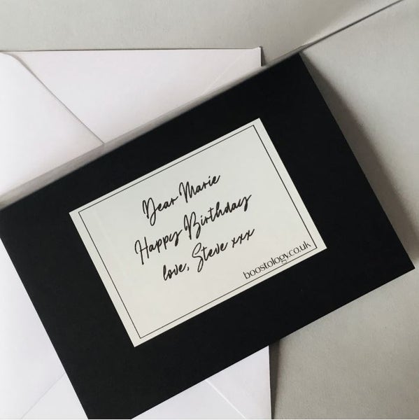 A luxury black card and envelope with personal gift message