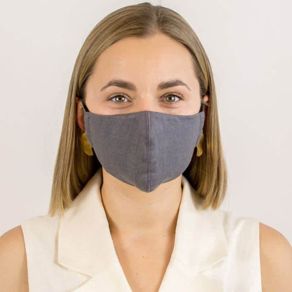 A woman wearing a grey linen 3 layer face mask